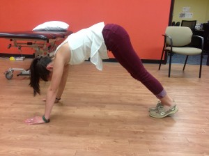 In this position Lindsay is stretching over-active muscles (back, calves) and facilitating muscles that are often found to be weak on swimmers (abdominal muscles, serratus anterior, triceps, lower trapezius)